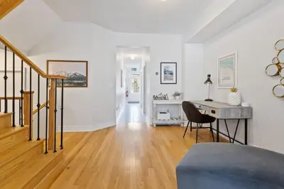 a white living room with a desk and a staircase at Mountain View Townhouse Fresh and Bright at Blue in Collingwood
