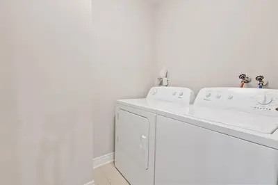 a white laundry room with a washer and dryer at Mountain View Townhouse Fresh and Bright at Blue in Collingwood