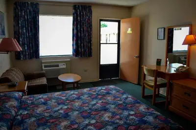 a hotel room with a bed and a desk at Lighthouse Motel in Walkerton
