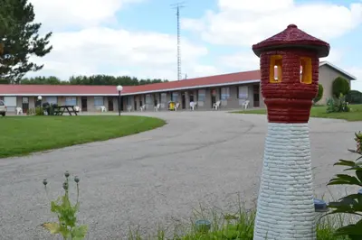 a red and white pole with a light on it at Lighthouse Motel in Walkerton