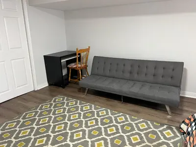 a living room with a couch and a desk at Cozy basement 2 bedroom 2 bath with parking in Richmond Hill