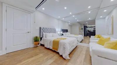 a large bedroom with two beds and a couch at Family Modern walkout Basement wSauna Indoor Fireplace Wifi in Innisfil