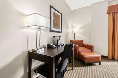 a hotel room with a desk and a chair at Best Western Plus Fergus Hotel in Fergus