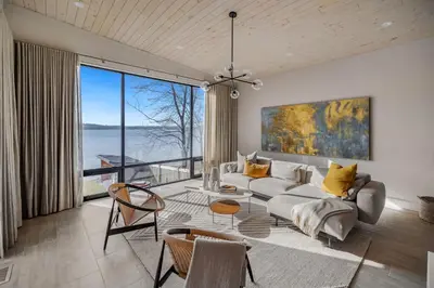 a living room with a couch and a large window at Lakeview House by Leavetown Vacations in Lakefield