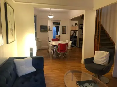 a living room with a couch and a table and chairs at Beautiful house in central Toronto with backyard in Toronto