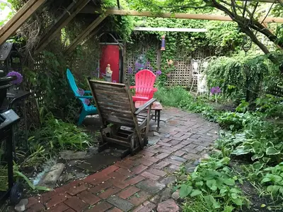 a group of chairs sitting in a garden at Beautiful house in central Toronto with backyard in Toronto