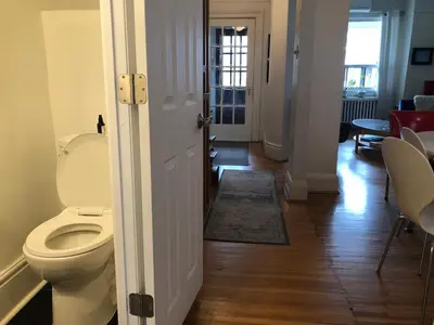 a bathroom with a toilet and a hallway at Beautiful house in central Toronto with backyard in Toronto