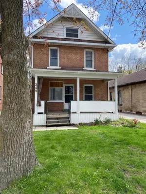 a brick house with a tree in the yard at France and Flowers - Private 3-Bed Apartment in Stratford