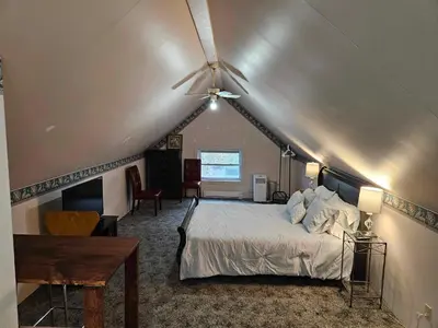 a bedroom with a bed with a ceiling fan at France and Flowers - Private 3-Bed Apartment in Stratford