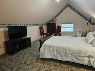 a bedroom with a bed and a flat screen tv at France and Flowers - Private 3-Bed Apartment in Stratford