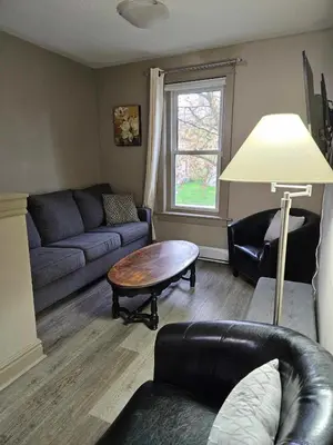 a living room with a couch and a table at France and Flowers - Private 3-Bed Apartment in Stratford