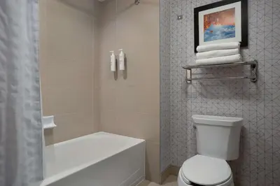 a bathroom with a white toilet and a shower at Homewood Suites by Hilton Waterloo/St. Jacobs in Waterloo