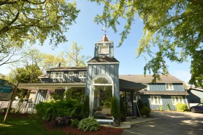 a house with a clock tower on the street at Windspire Inn in Port Elgin