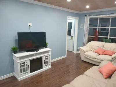a living room with a flat screen tv and a couch at Windspire Inn in Port Elgin