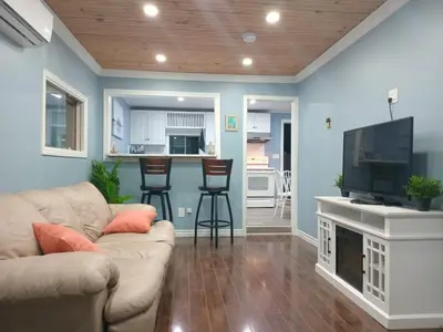 a living room with a couch and a flat screen tv at Windspire Inn in Port Elgin