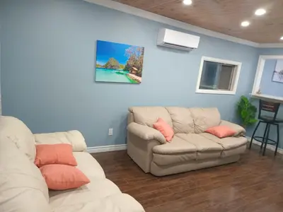 a living room with two couches and a couch at Windspire Inn in Port Elgin