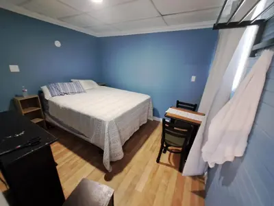 a bedroom with a bed and a desk in a room at Windspire Inn in Port Elgin
