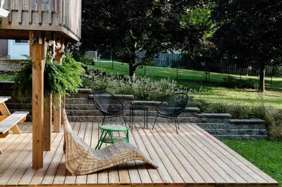 two chairs and a table on a wooden deck at The Dainty Petunia in Picton