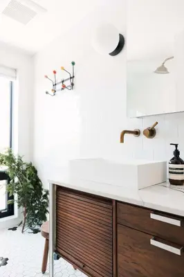 a white kitchen with a sink and a counter at Hart House a fresh 3 bedroom century home in Cherry Valley
