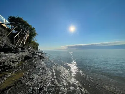 a view of the ocean from a rocky shore at The Hull House - Lake Ontario Waterfront w Sauna in Wellington
