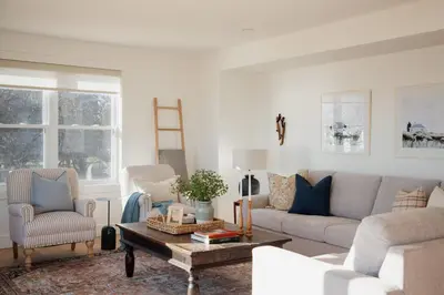 a living room with a couch and chairs and a table at The Hull House - Lake Ontario Waterfront w Sauna in Wellington