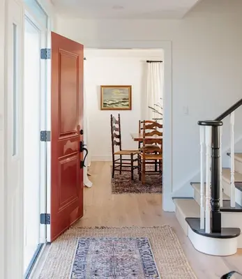 a hallway with a door leading to a dining room at The Hull House - Lake Ontario Waterfront w Sauna in Wellington