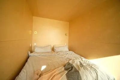 a small bedroom with a bed in the corner at Hygge House Cozy Boutique Guest House in Hillier