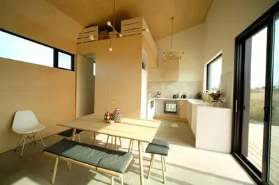 a kitchen and dining room with a wooden table and chairs at Hygge House Cozy Boutique Guest House in Hillier