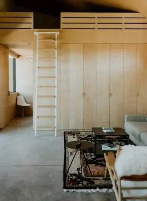 a living room with a loft bed and a table at Hygge House Cozy Boutique Guest House in Hillier