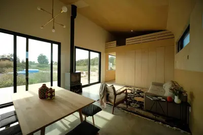 a living room with a table and a couch at Hygge House Cozy Boutique Guest House in Hillier