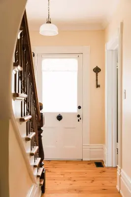 a hallway with a white door and a window at Watson House - Century Home near Sandbanks in Cherry Valley