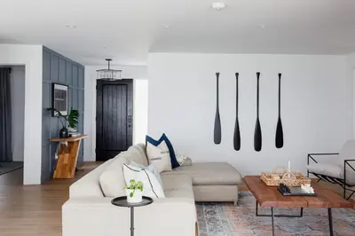 a living room with a couch and a table at Wellers Landing - Prince Edward County Lakehouse in Carrying Place