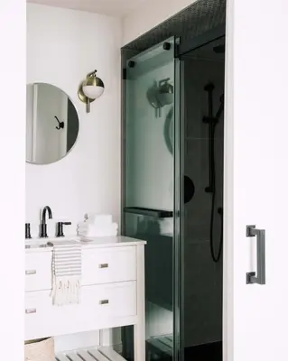 a bathroom with a shower and a sink and a mirror at Wellers Landing - Prince Edward County Lakehouse in Carrying Place