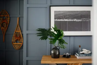 a plant in a vase on a table in a room at Wellers Landing - Prince Edward County Lakehouse in Carrying Place