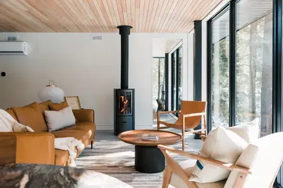a living room with a couch and a fireplace at nortehaus - Nordic and Japanese inspired escape in Norland