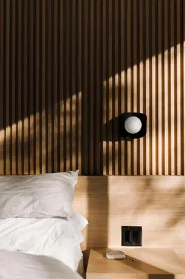 a bedroom with a bed with a wooden head board at nortehaus - Nordic and Japanese inspired escape in Norland