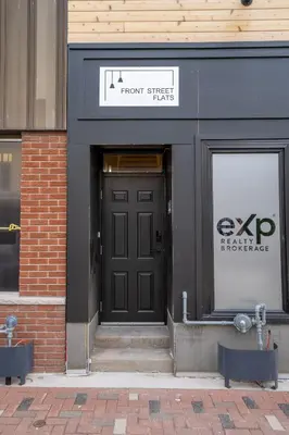 a front entrance to a store with a black door at The Goodman: Front Street Flats in Belleville