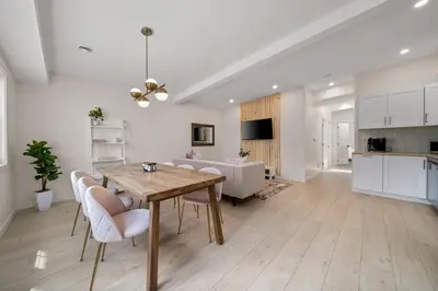 a kitchen and living room with a wooden table and chairs at The Belvedere:Front Street Flats in Belleville