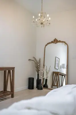 a bedroom with a mirror and a bed at The Belvedere:Front Street Flats in Belleville
