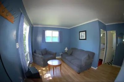 a living room with a couch and a table at Muskoka Shores Cottages in Port Carling