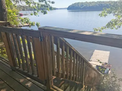 a wooden deck with a view of a lake at Muskoka Shores Cottages in Port Carling