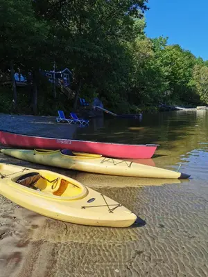 a group of kayaks sitting on the shore of a river at Muskoka Shores Cottages in Port Carling