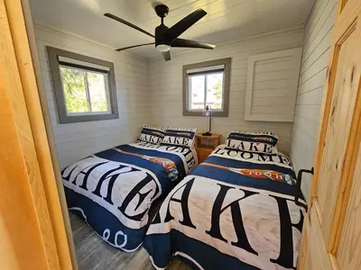 a bedroom with two beds and a ceiling fan at Muskoka Shores Cottages in Port Carling