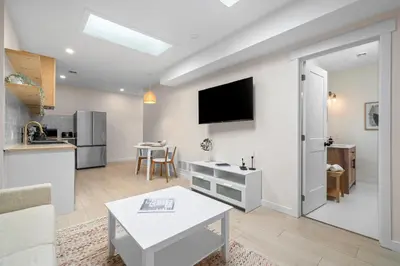 a living room with a couch and a table at The Olympia: Front Street Flats in Belleville