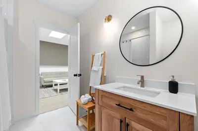 a bathroom with a sink and a mirror on the wall at The Olympia: Front Street Flats in Belleville