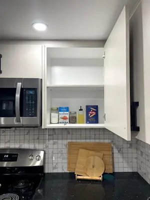 a kitchen with a wooden cutting board on the counter at Niagara Falls BNB 15 mins away from Falls in Thorold