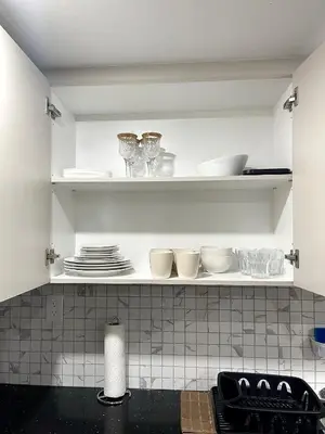 a kitchen shelf with dishes and plates on it at Niagara Falls BNB 15 mins away from Falls in Thorold