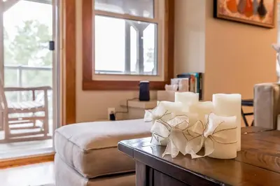 a room with a bed and a table with candles at Muskoka Lakeshore Cottage Bliss in Gravenhurst
