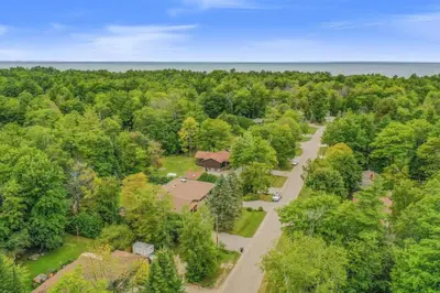 an aerial view of a house in a forest at Blue Water Dunes Cottage in Tiny