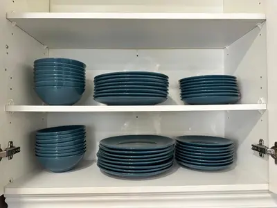 a group of blue plates on a shelf at Lavish 4BR House Near Simcoe Lake & FH Resort in Innisfil